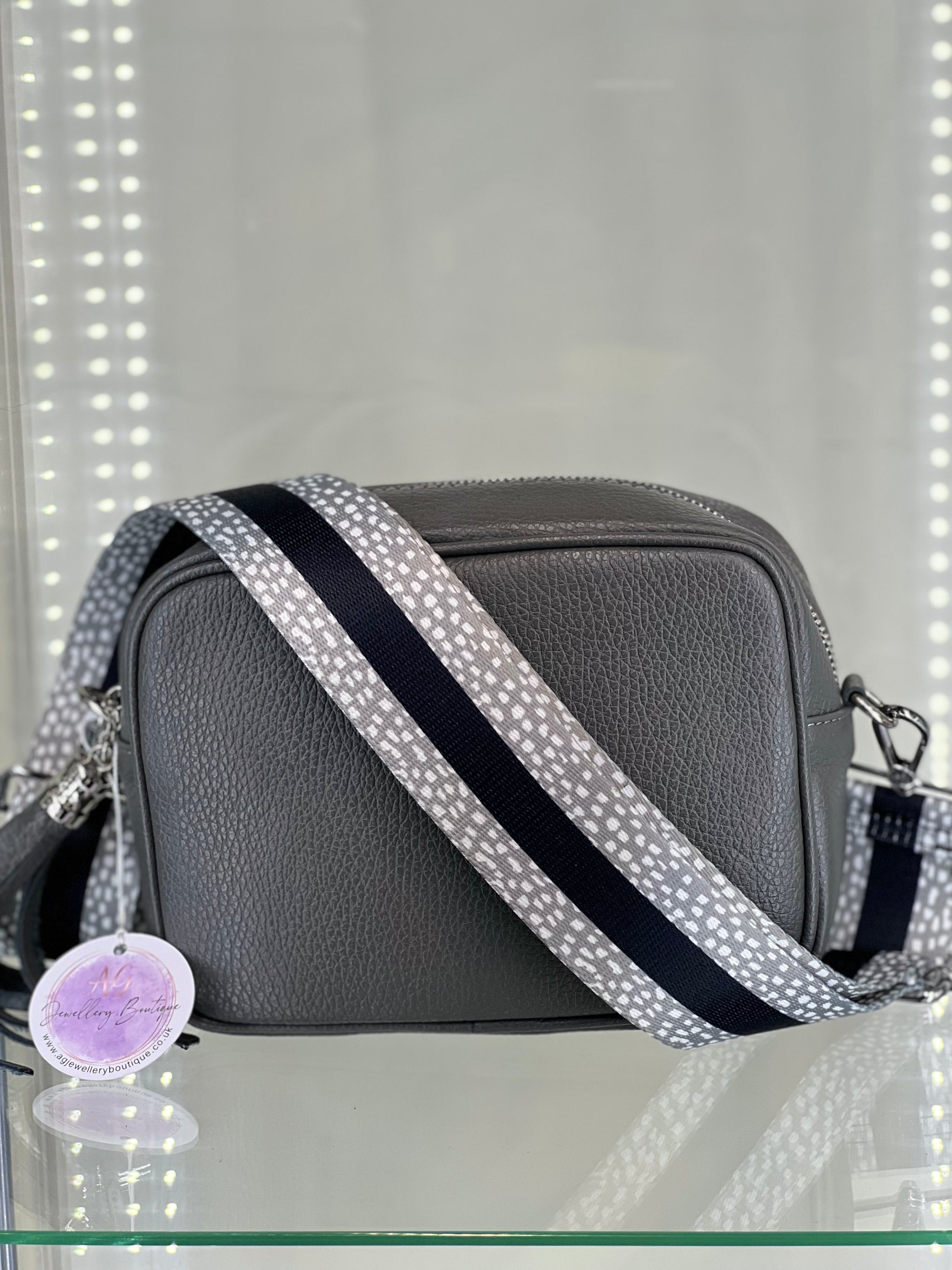 Crossbody bag with striped strap best sale